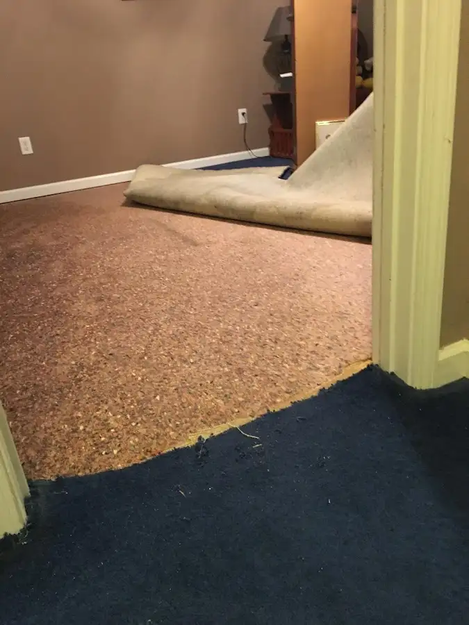 Carpet pad removal revealing water damage during Drying & Dehumidification in Cherokee